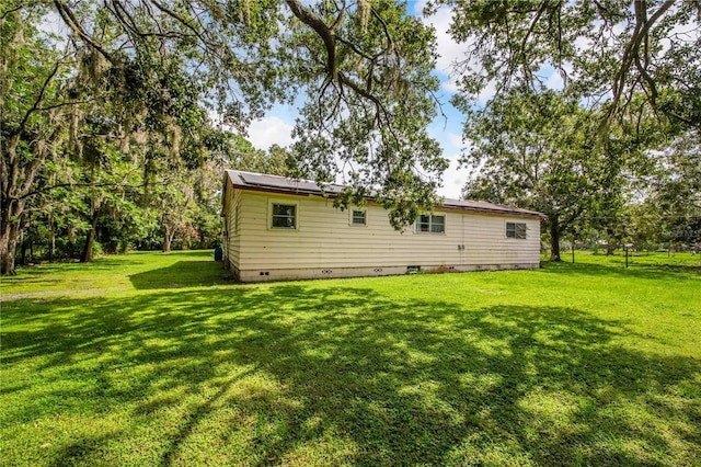 4430 1st St NW, Lakeland, FL 33810 - back of house featuring crawl space and a lawn