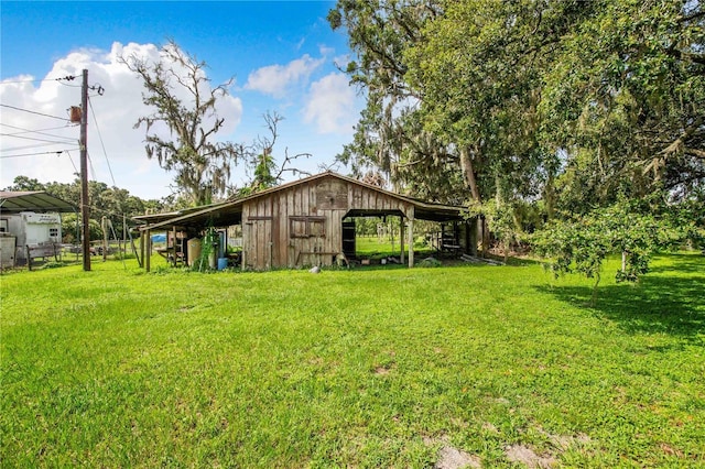 4430 1st St NW, Lakeland, FL 33810 - view of yard with a detached carport and an outbuilding