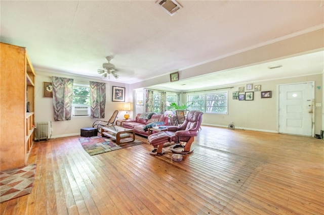 4430 1st St NW, Lakeland, FL 33810 - living room with healthy amount of natural light, light wood-style flooring, crown molding, radiator, and ceiling fan