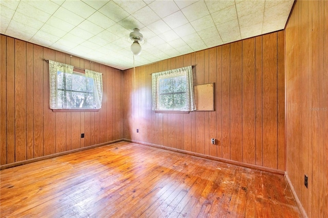4430 1st St NW, Lakeland, FL 33810 - spare room with plenty of natural light, hardwood / wood-style flooring, and wood walls