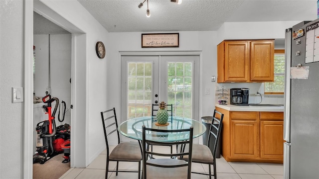 815 Everett St, Lake Alfred, FL 33850 - dining area featuring a textured ceiling, french doors, and light tile patterned floors