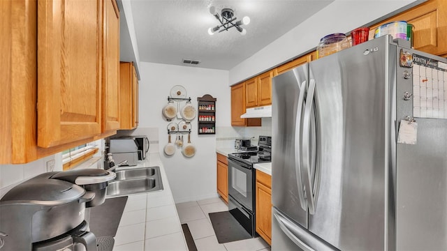 815 Everett St, Lake Alfred, FL 33850 - kitchen featuring freestanding refrigerator, black electric range, under cabinet range hood, tile counters, and light tile patterned floors