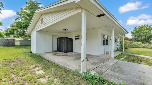 815 Everett St, Lake Alfred, FL 33850 - rear view of property with a patio area, concrete driveway, stucco siding, and a carport