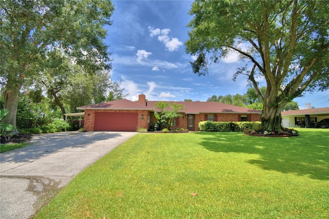 2814 Grapefruit Dr, Auburndale, FL 33823 - ranch-style house with an attached garage, a front lawn, driveway, brick siding, and a chimney