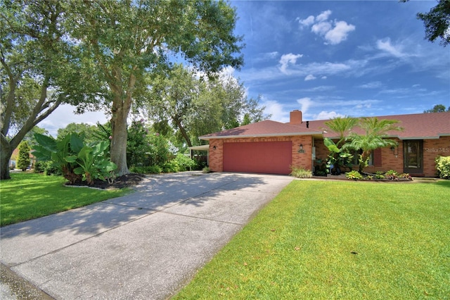 2814 Grapefruit Dr, Auburndale, FL 33823 - ranch-style house with an attached garage, concrete driveway, a front lawn, a chimney, and brick siding