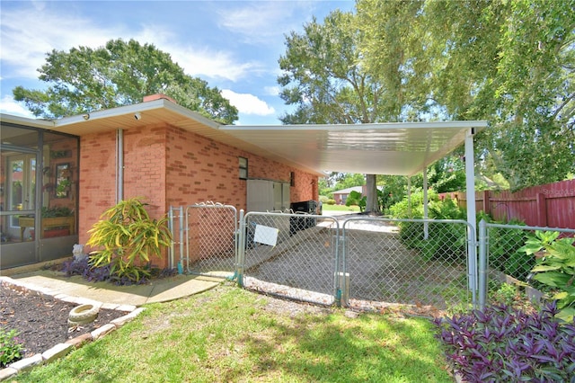 2814 Grapefruit Dr, Auburndale, FL 33823 - view of property exterior featuring a gate, an attached carport, and brick siding