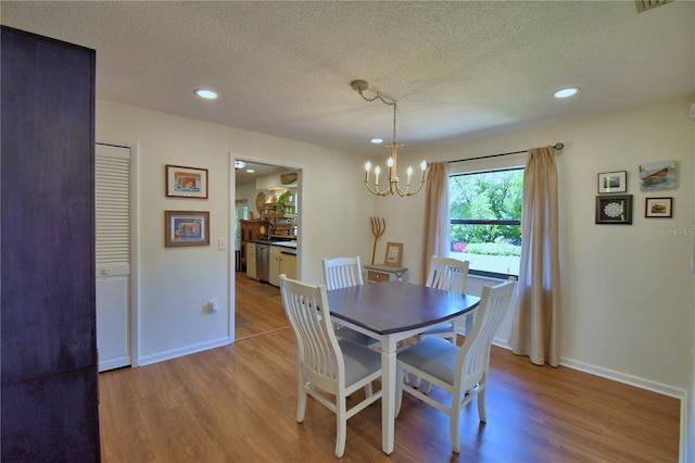 2814 Grapefruit Dr, Auburndale, FL 33823 - dining space featuring wood finished floors, a chandelier, a textured ceiling, and recessed lighting