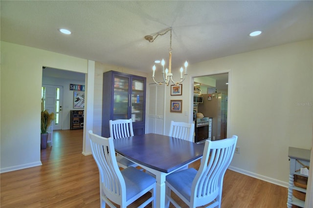 2814 Grapefruit Dr, Auburndale, FL 33823 - dining room with a chandelier, light wood finished floors, and recessed lighting