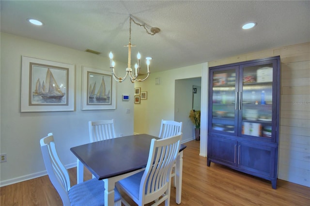 2814 Grapefruit Dr, Auburndale, FL 33823 - dining area with a chandelier, wood finished floors, a textured ceiling, and recessed lighting