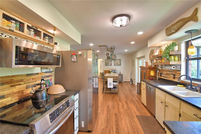 2814 Grapefruit Dr, Auburndale, FL 33823 - kitchen featuring appliances with stainless steel finishes, open shelves, light wood-style floors, recessed lighting, and dark countertops