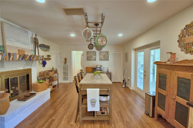 2814 Grapefruit Dr, Auburndale, FL 33823 - dining area featuring a fireplace, light wood finished floors, and recessed lighting