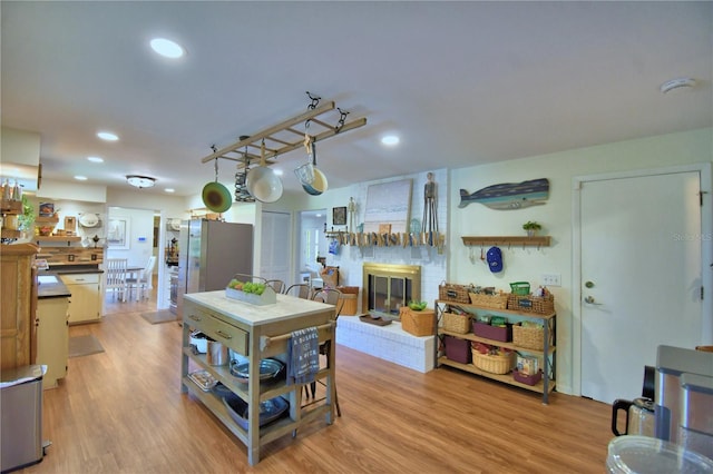 2814 Grapefruit Dr, Auburndale, FL 33823 - kitchen featuring freestanding refrigerator, light wood-style flooring, a fireplace, and recessed lighting