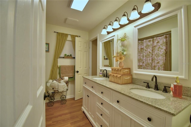 2814 Grapefruit Dr, Auburndale, FL 33823 - bathroom featuring double vanity and wood finished floors
