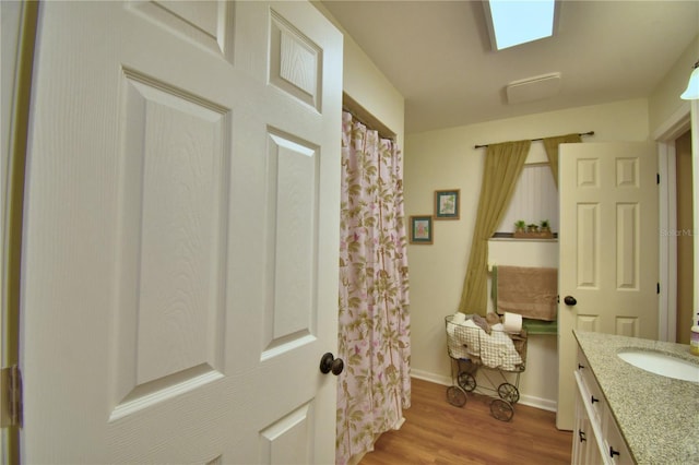 2814 Grapefruit Dr, Auburndale, FL 33823 - full bath with vanity, wood finished floors, and a shower with shower curtain