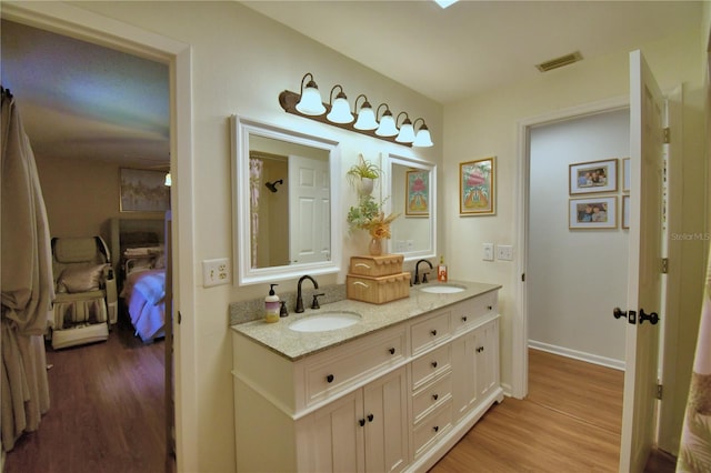 2814 Grapefruit Dr, Auburndale, FL 33823 - full bath featuring wood finished floors and double vanity