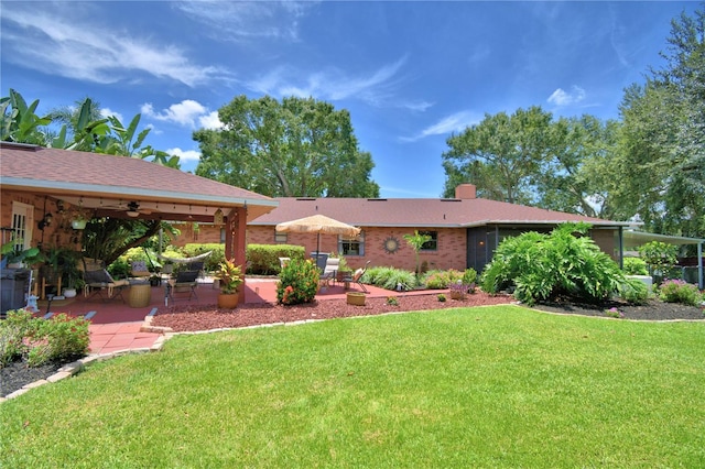 2814 Grapefruit Dr, Auburndale, FL 33823 - view of front facade with a ceiling fan, a front lawn, a patio, and a chimney
