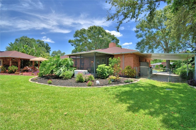 2814 Grapefruit Dr, Auburndale, FL 33823 - view of yard with an attached carport, a sunroom, and a gate