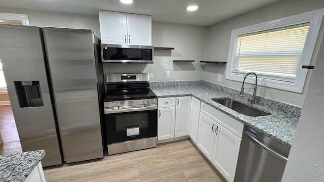 713 4th St NE, Fort Meade, FL 33841 - kitchen featuring appliances with stainless steel finishes, open shelves, white cabinetry, light wood-style floors, and recessed lighting