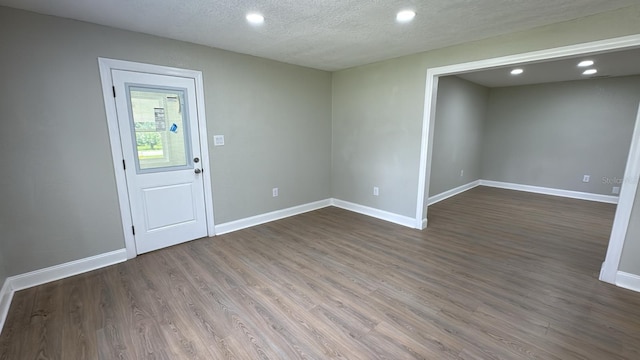 713 4th St NE, Fort Meade, FL 33841 - empty room featuring dark wood finished floors, recessed lighting, and a textured ceiling