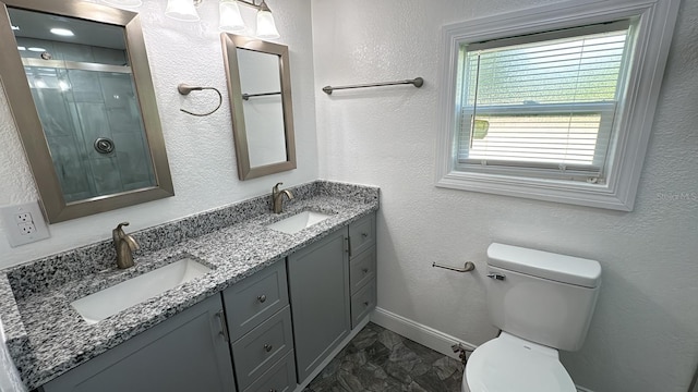 713 4th St NE, Fort Meade, FL 33841 - bathroom featuring marble finish flooring, double vanity, and a shower with door