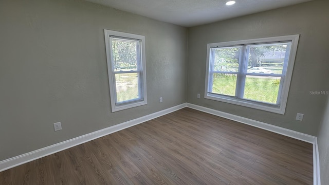 713 4th St NE, Fort Meade, FL 33841 - empty room featuring healthy amount of natural light, dark wood-style flooring, and recessed lighting