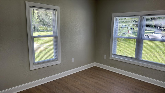 713 4th St NE, Fort Meade, FL 33841 - spare room featuring dark wood-type flooring and a textured wall