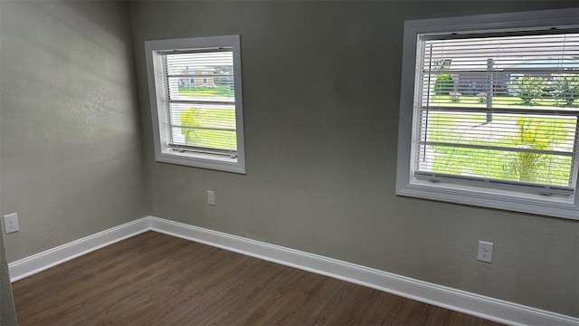 713 4th St NE, Fort Meade, FL 33841 - spare room featuring baseboards and dark wood-type flooring