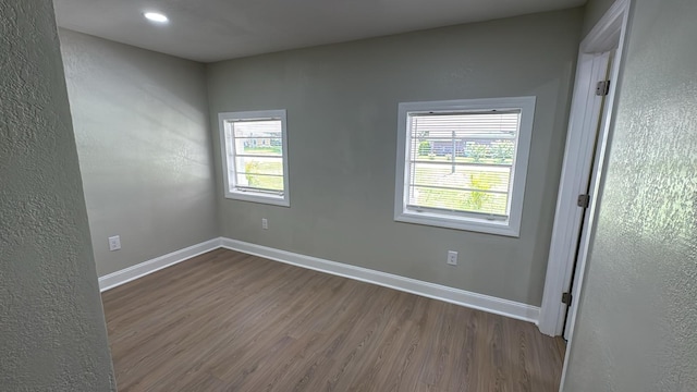 713 4th St NE, Fort Meade, FL 33841 - empty room with dark wood finished floors and plenty of natural light