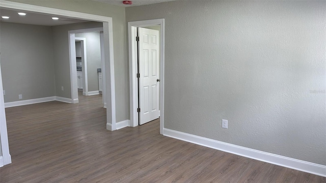 713 4th St NE, Fort Meade, FL 33841 - empty room with dark wood-style flooring and recessed lighting