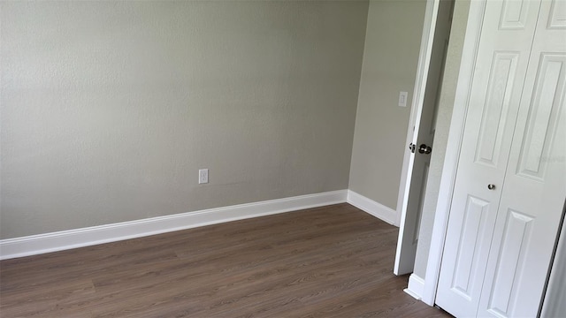 713 4th St NE, Fort Meade, FL 33841 - unfurnished bedroom featuring dark wood-style floors and a closet