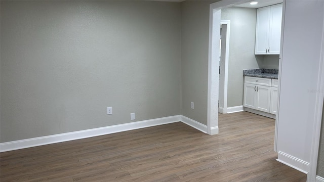 713 4th St NE, Fort Meade, FL 33841 - unfurnished dining area featuring wood finished floors and baseboards