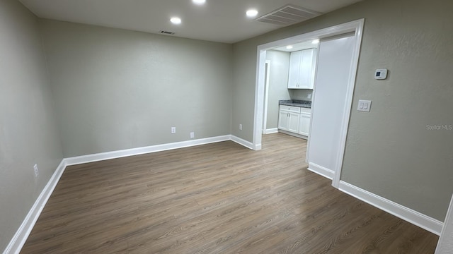 713 4th St NE, Fort Meade, FL 33841 - spare room featuring wood finished floors and recessed lighting