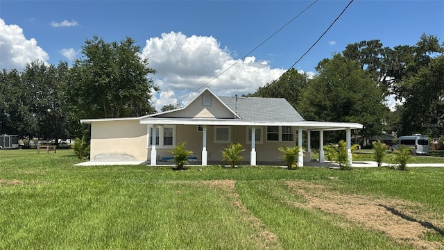713 4th St NE, Fort Meade, FL 33841 - view of front of property with a front lawn, covered porch, and stucco siding