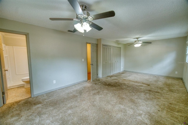 415 Boger Blvd N, Lakeland, FL 33803 - unfurnished bedroom with carpet floors, a ceiling fan, a textured ceiling, connected bathroom, and a closet