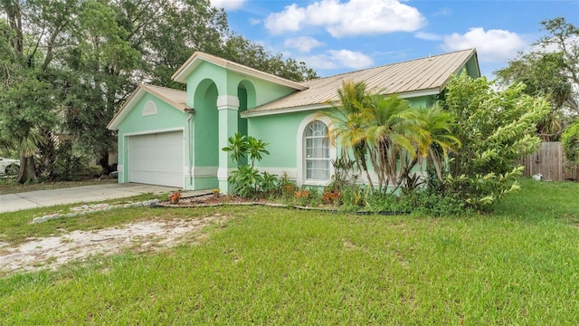 912 Whisper Lake Dr, Winter Haven, FL 33880 - view of front of home with stucco siding, concrete driveway, a garage, and a metal roof