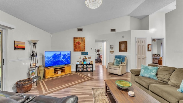 912 Whisper Lake Dr, Winter Haven, FL 33880 - living area featuring wood finished floors and high vaulted ceiling