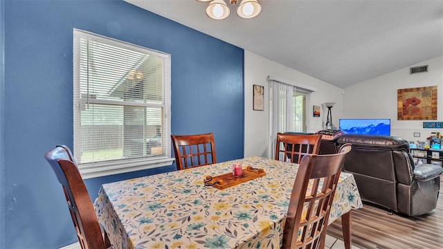 912 Whisper Lake Dr, Winter Haven, FL 33880 - dining space featuring vaulted ceiling and wood finished floors