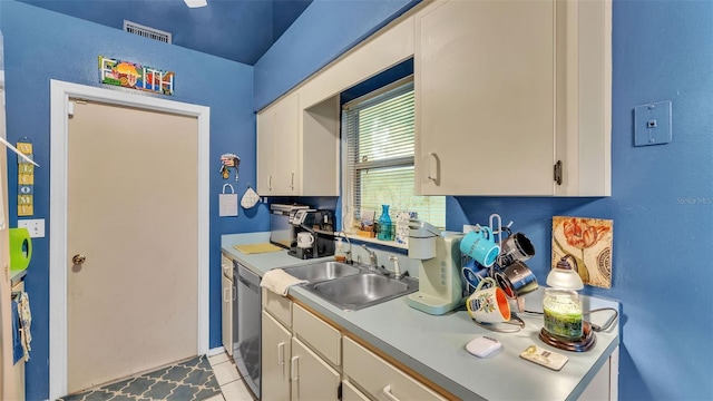 912 Whisper Lake Dr, Winter Haven, FL 33880 - kitchen with light countertops, dishwasher, and white cabinetry