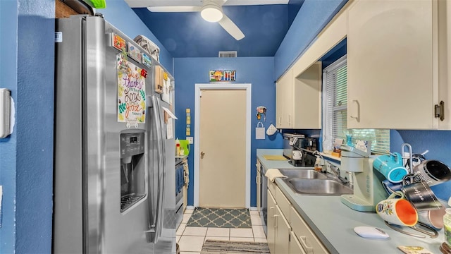 912 Whisper Lake Dr, Winter Haven, FL 33880 - kitchen featuring stainless steel fridge, a ceiling fan, light countertops, light tile patterned floors, and white cabinets