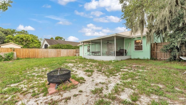 912 Whisper Lake Dr, Winter Haven, FL 33880 - back of property with a sunroom, a fire pit, a ceiling fan, and a fenced backyard