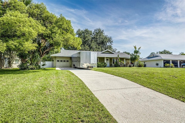2056 Broken Arrow Trl N, Lakeland, FL 33813 - view of front facade with concrete driveway, an attached garage, and a front yard