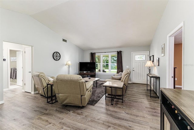 2056 Broken Arrow Trl N, Lakeland, FL 33813 - living room featuring vaulted ceiling and light wood-style floors