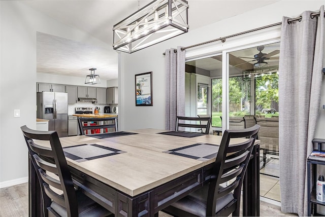 2056 Broken Arrow Trl N, Lakeland, FL 33813 - dining space with a chandelier and baseboards