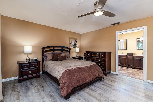 2056 Broken Arrow Trl N, Lakeland, FL 33813 - bedroom featuring wood finished floors, ensuite bath, and ceiling fan
