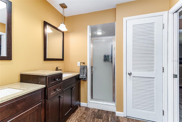 2056 Broken Arrow Trl N, Lakeland, FL 33813 - full bathroom featuring wood finished floors, a shower stall, and two vanities