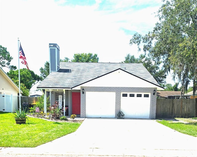 985 Whisper Lk, Winter Haven, FL 33880 - ranch-style house featuring an attached garage, brick siding, driveway, and a chimney