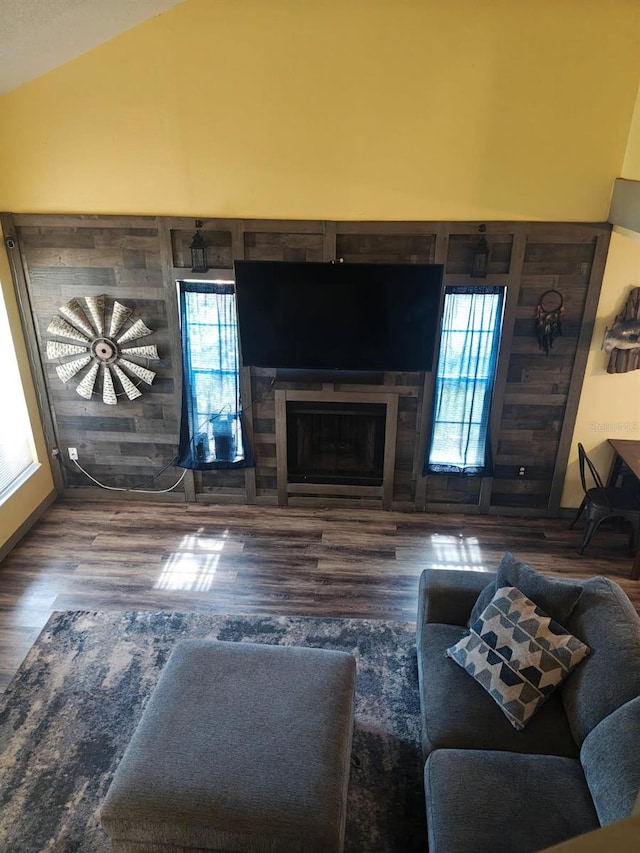 985 Whisper Lk, Winter Haven, FL 33880 - living room with wood finished floors, plenty of natural light, lofted ceiling, and a fireplace
