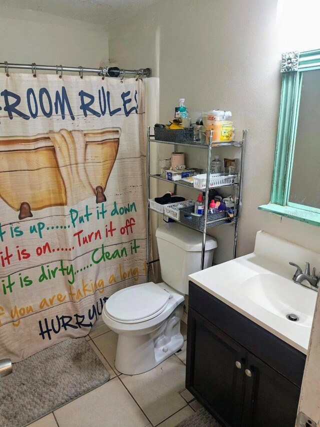 985 Whisper Lk, Winter Haven, FL 33880 - bathroom with vanity, tile patterned flooring, and a shower with shower curtain