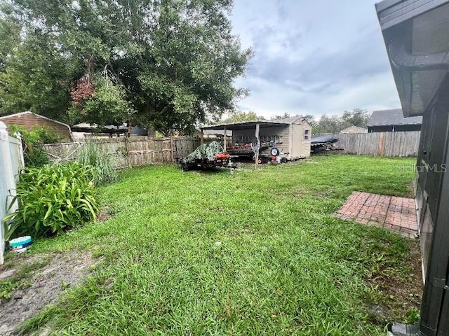985 Whisper Lk, Winter Haven, FL 33880 - fenced backyard with a storage shed and a carport