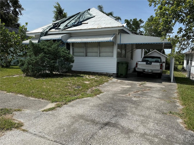 724 Ave D SW, Winter Haven, FL 33880 - view of front facade with a carport, a front lawn, and concrete driveway